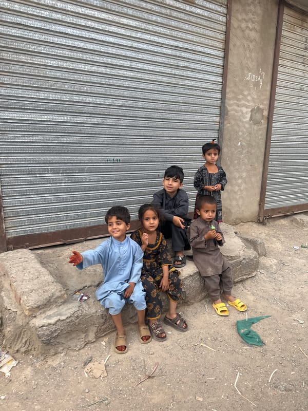 Five children lie near closed storefront in Quetta