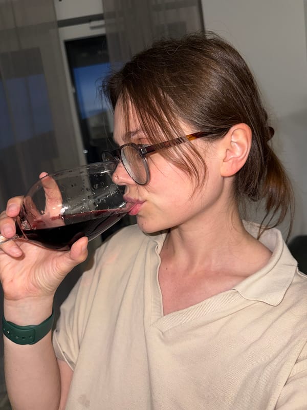 Woman enjoys wine at indoor location in Balatonlelle