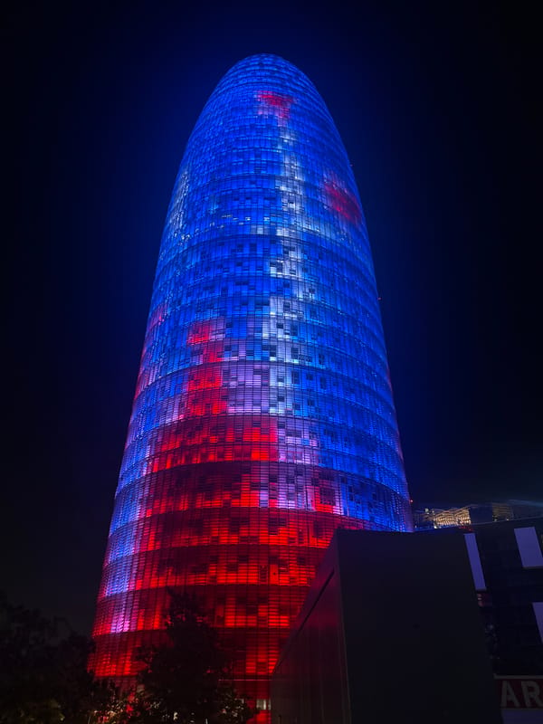 Night in Barcelona: Torre Agbar glows over a quiet park