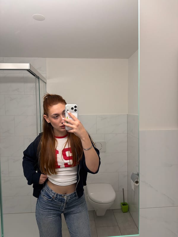 Woman takes bathroom mirror selfies in Bremgarten, Switzerland