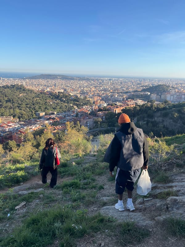 Person stands at elevated Barcelona viewpoint wearing distinctive outfit