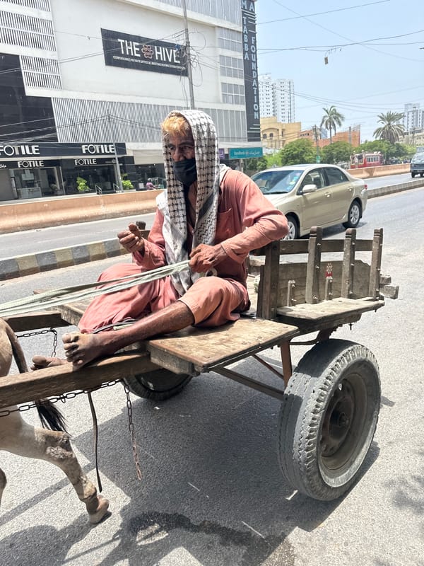 Karachi street life: deliveries, carts, and sidewalk moments