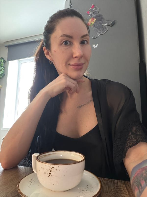 Woman photographed with cat, glass in Perm home morning