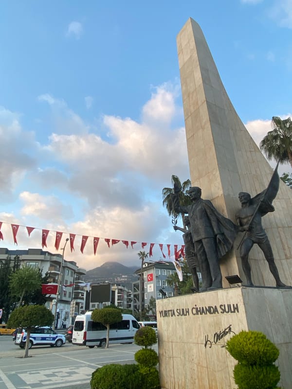 Spring flowers bloom in Alanya public garden, cat spotted among beds