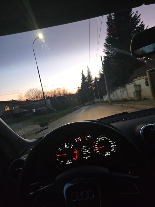 Driver pauses on road during sunset, radio playing