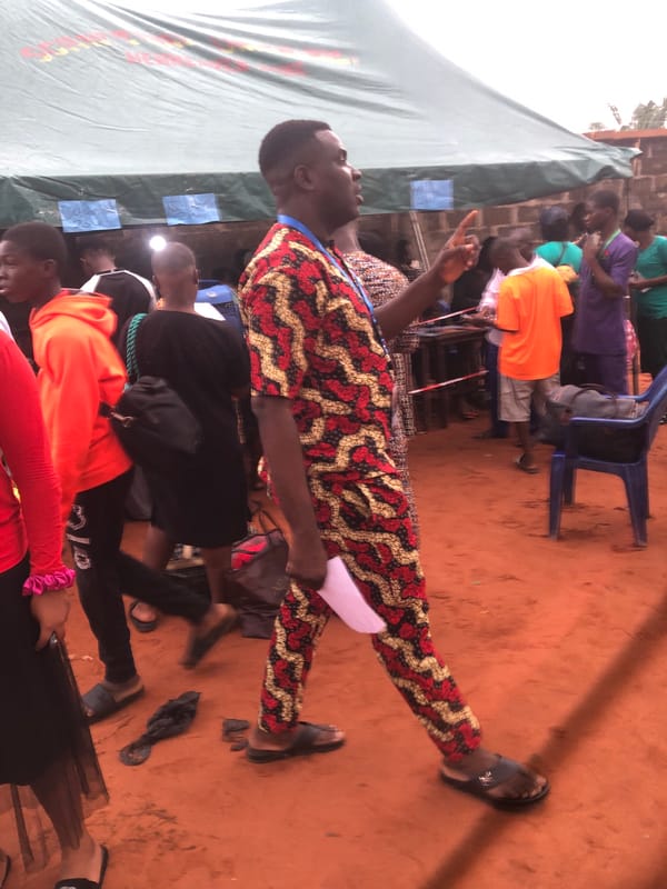 Outdoor gathering under tent in Nteje, Nigeria