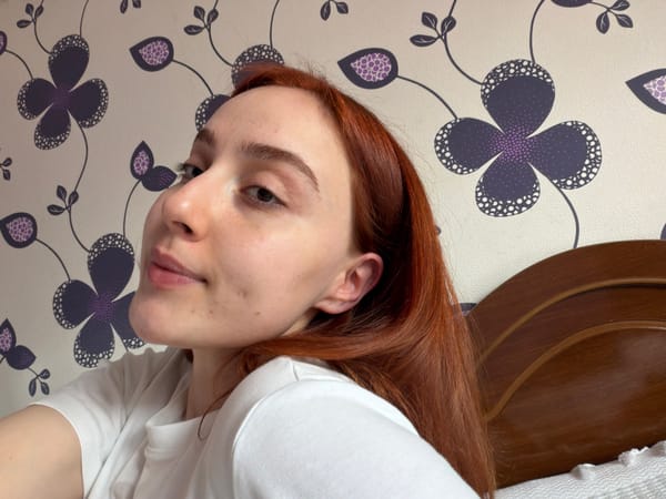 Person photographed in bedroom during morning hours in Tbilisi