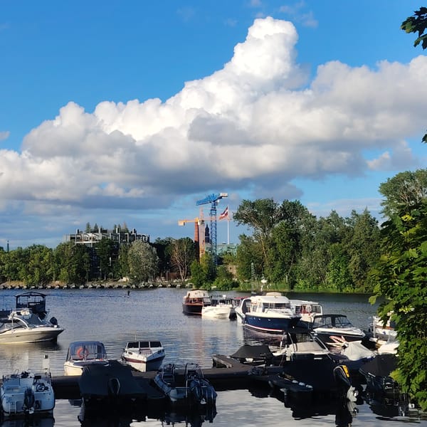 Riga harbor on a sunny afternoon, boats moored, Z-Towers in view