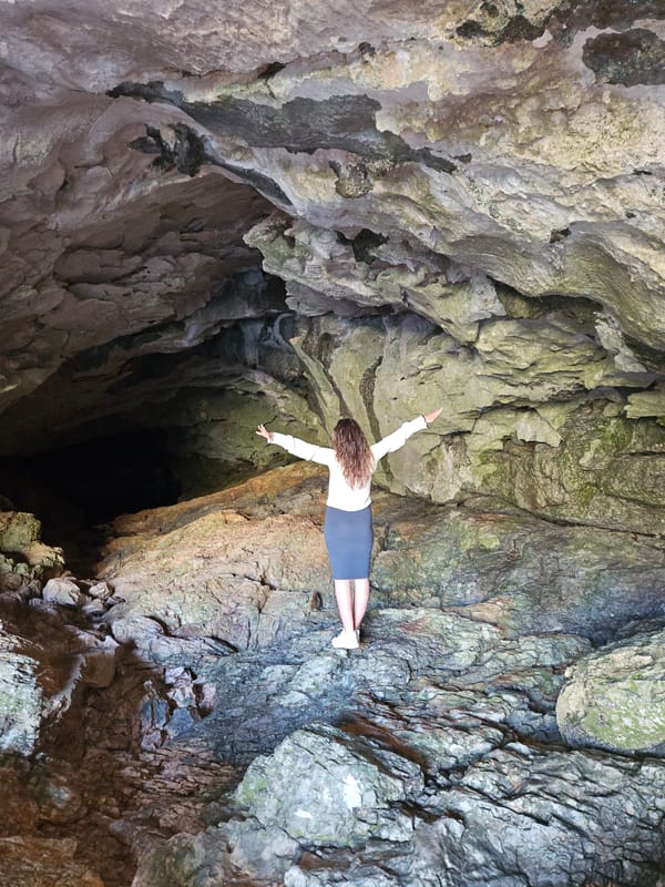 Woman in white shirt observed moving inside cave