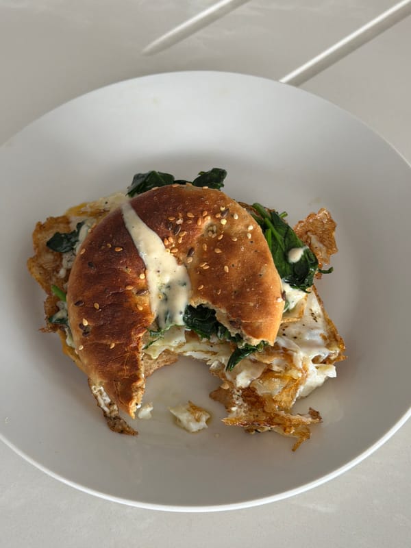 Half-eaten breakfast bagel sandwich documented in London