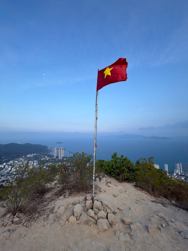 Vietnamese flag flies on rugged terrain near Nha Trang