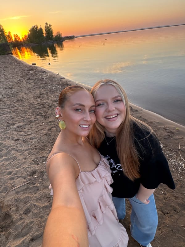 Two women take sunset selfies on Chaikovsky beach