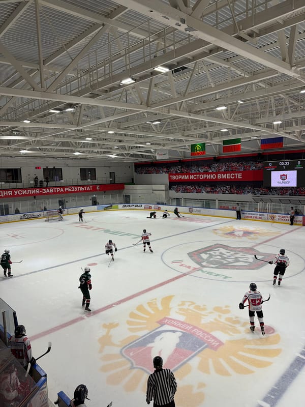 Hockey game underway at Almetyevsk arena with corporate sponsors