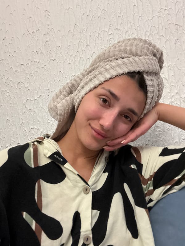 Woman in towel and patterned clothing observed in Sutomore