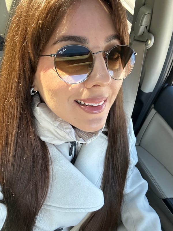 Woman smiles in car front seat, Riga Latvia