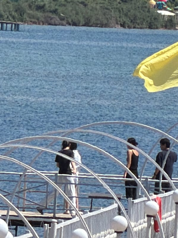 Laid-back waterfront day with people along the shore
