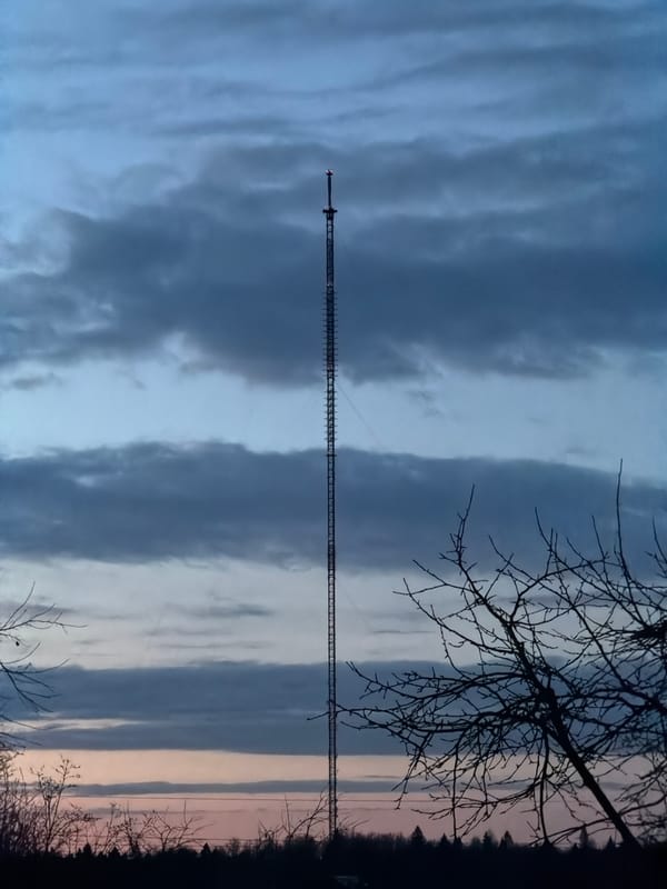 Radio tower observed under cloudy skies in rural Russia