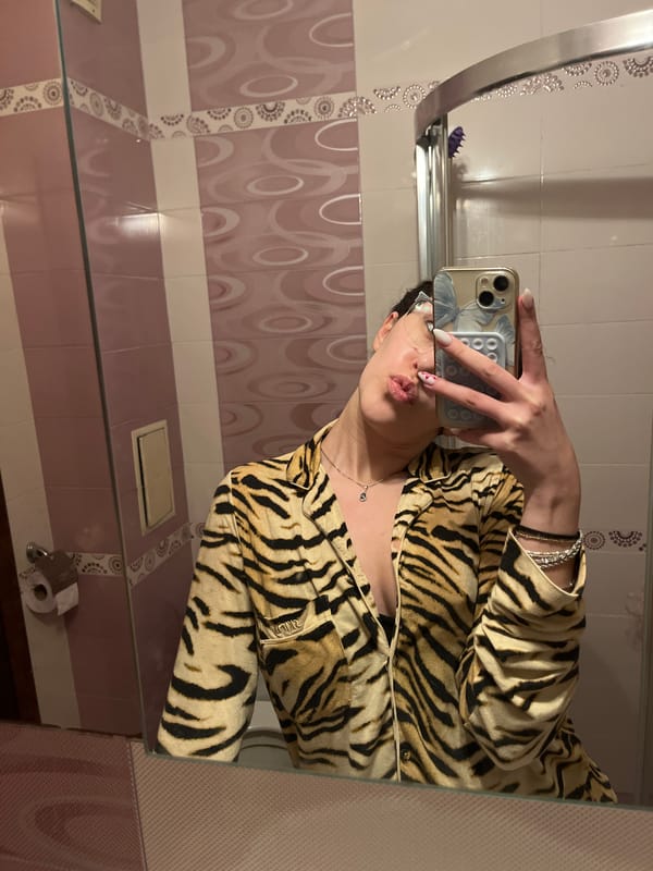 Person takes bathroom selfies in tiger-striped shirt in Sofia