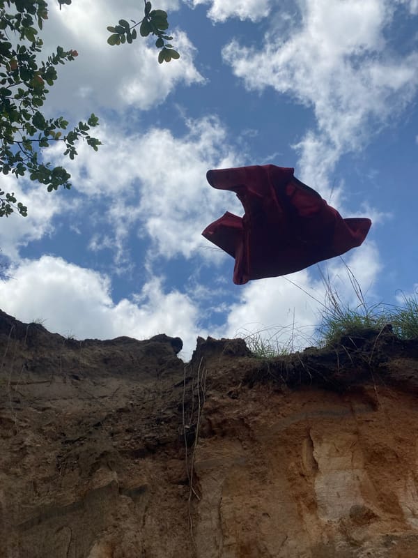 Red cloth caught suspended mid-air near cliff in Amaseri