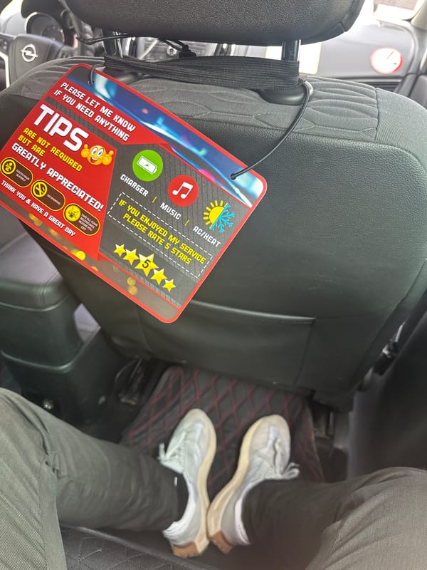 Driver displays customer service sign in Sofia vehicle