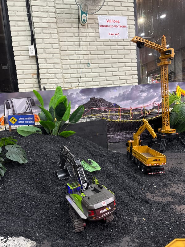 Family visits RC construction toy center during Vietnam rainstorm