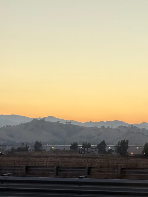 Dry field and wooden fence under a Vacaville sunset sky