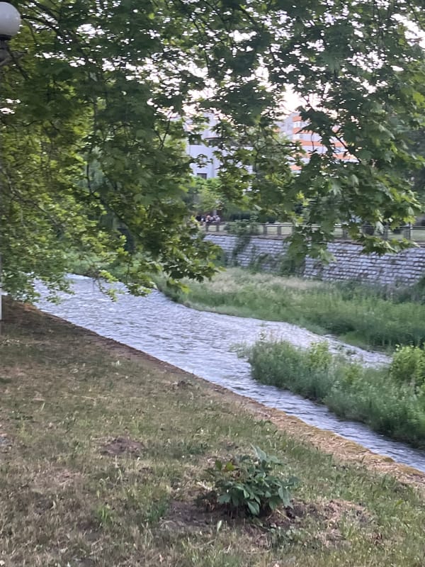 Person documents walking tour through Blagoevgrad's urban waterways and campus