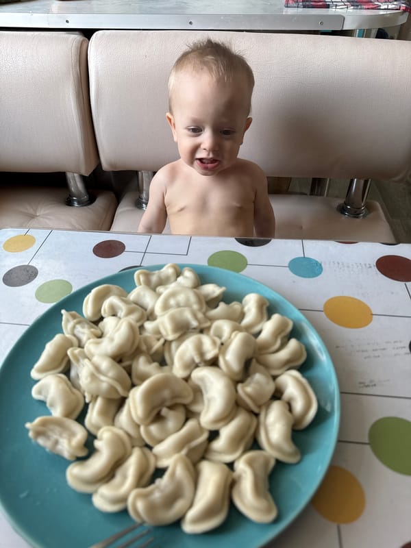 Child enjoys traditional pelmeni meal in Chaikovsky, Russia