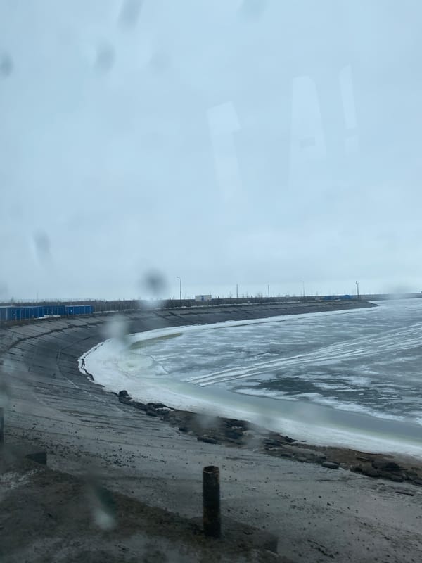 Ice-covered water observed near buildings in Chaikovsky, Russia
