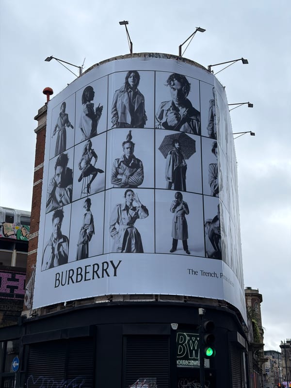Pedestrian passes Burberry billboard during morning walk in London