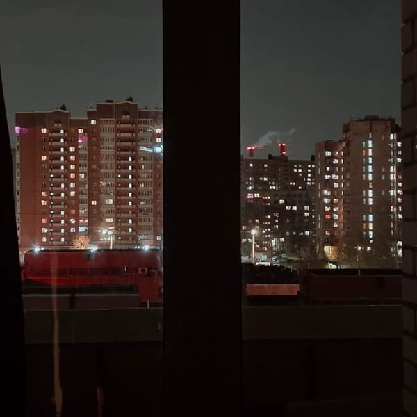 Illuminated apartment building captured at night in Saint Petersburg