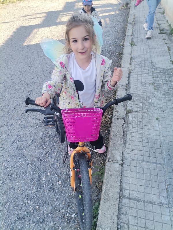 Child with bicycle spotted on cobblestone street in Bulgaria