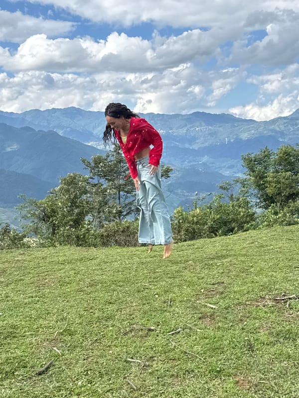 Tourists jump and pose on Tu Le hilltop during morning visit