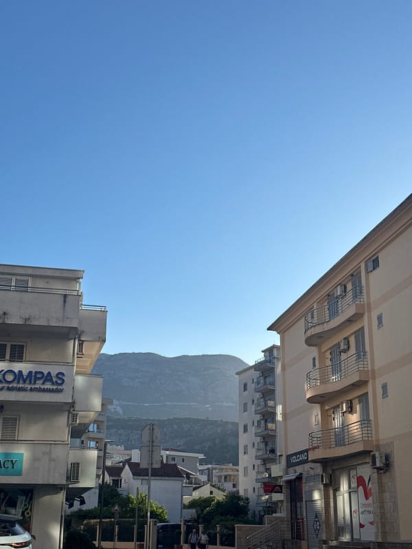 Woman documents morning coffee routine at Budva cafe