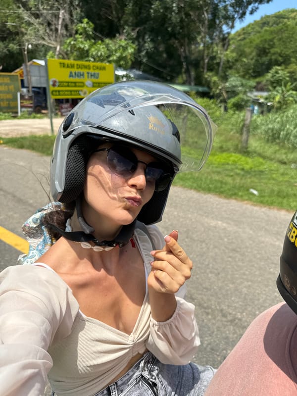 Woman on motorcycle encounters cattle herd on rural Vietnam road