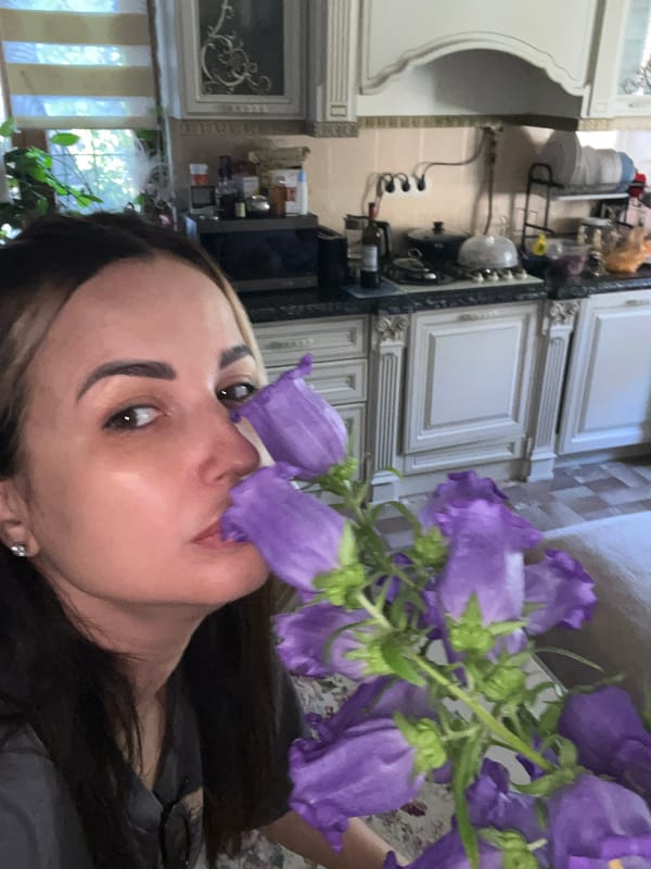 Woman documents morning moment with flowers in home selfies