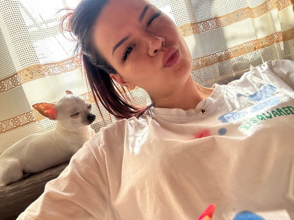 Woman poses with white chihuahua in Bulgarian home
