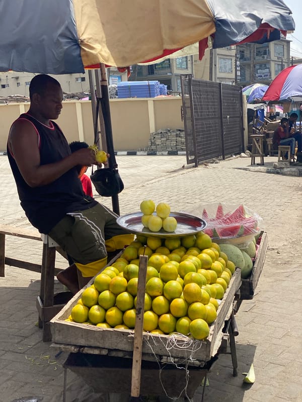 Street vendors carry food goods on heads in Lagos