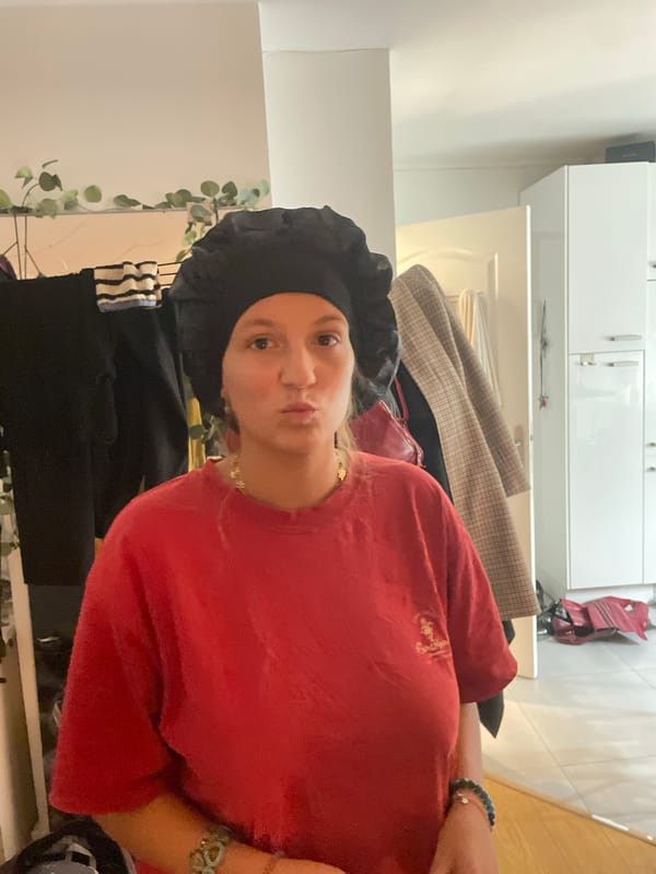 Woman in black bonnet observed in Pantin indoor setting