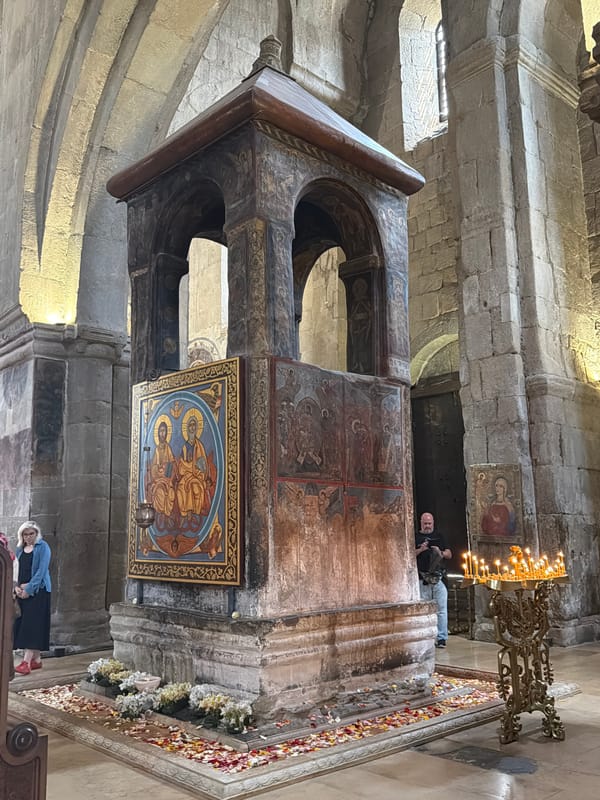 Visitor documents historic cathedral interiors in Mtskheta, Georgia