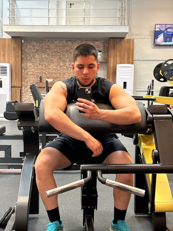 Man exercises at Sofia gym, uses leg press machine