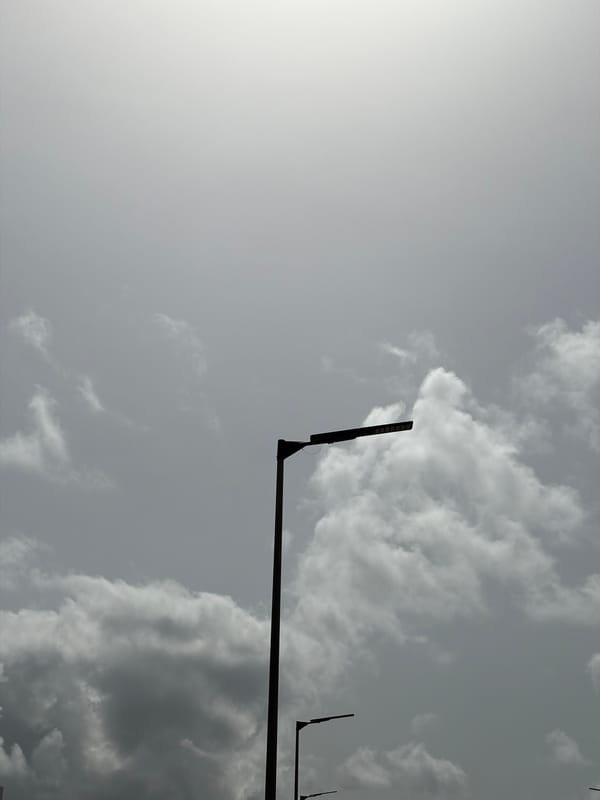 Workers commute by truck under cloudy skies in Igboefon