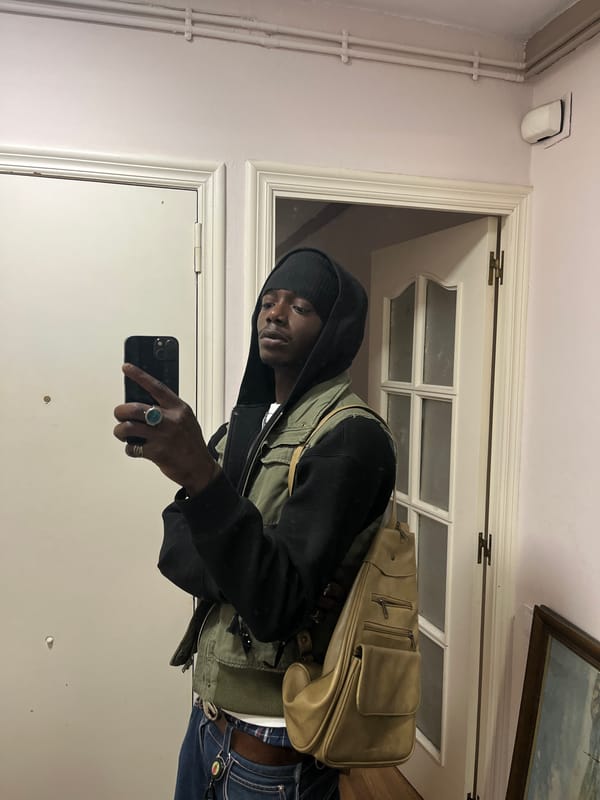 Person takes mirror selfie in Barcelona hallway