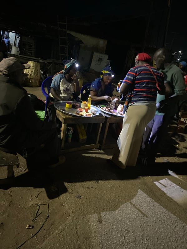 Night market vendors serve street food in Bukuru, Nigeria