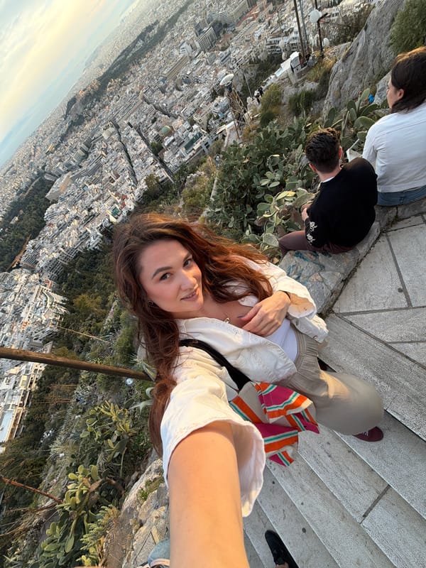 Woman takes sunset selfies at Athens scenic overlook