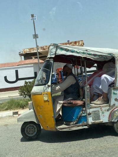 Colorful auto rickshaw travels through Kandahar streets