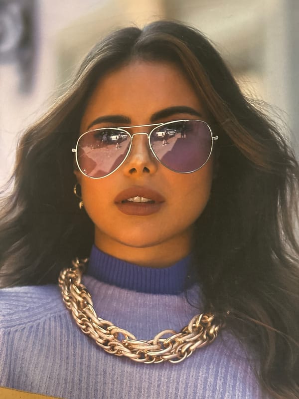 Woman in aviators and gold chain observed twice