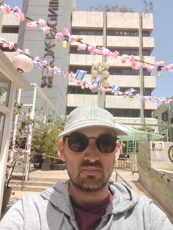 Man takes selfie near MINDSPACE building in Tel Aviv