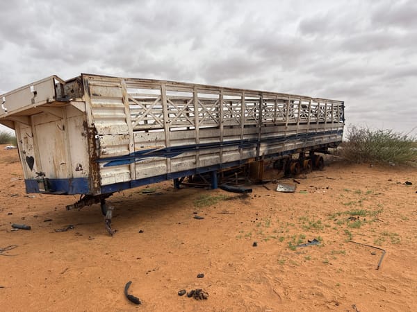 Abandoned livestock trailer rusting in Sudan's desert terrain