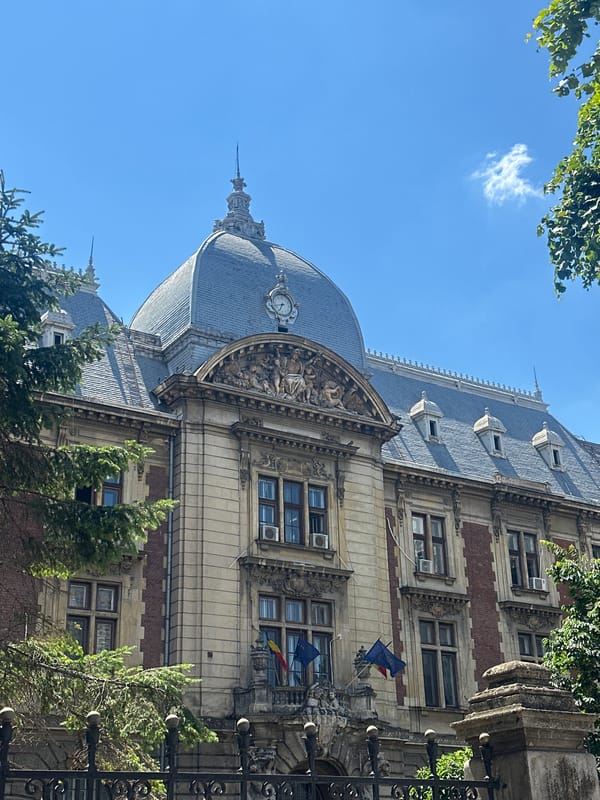 Domed classical building with ornate details on a clear day